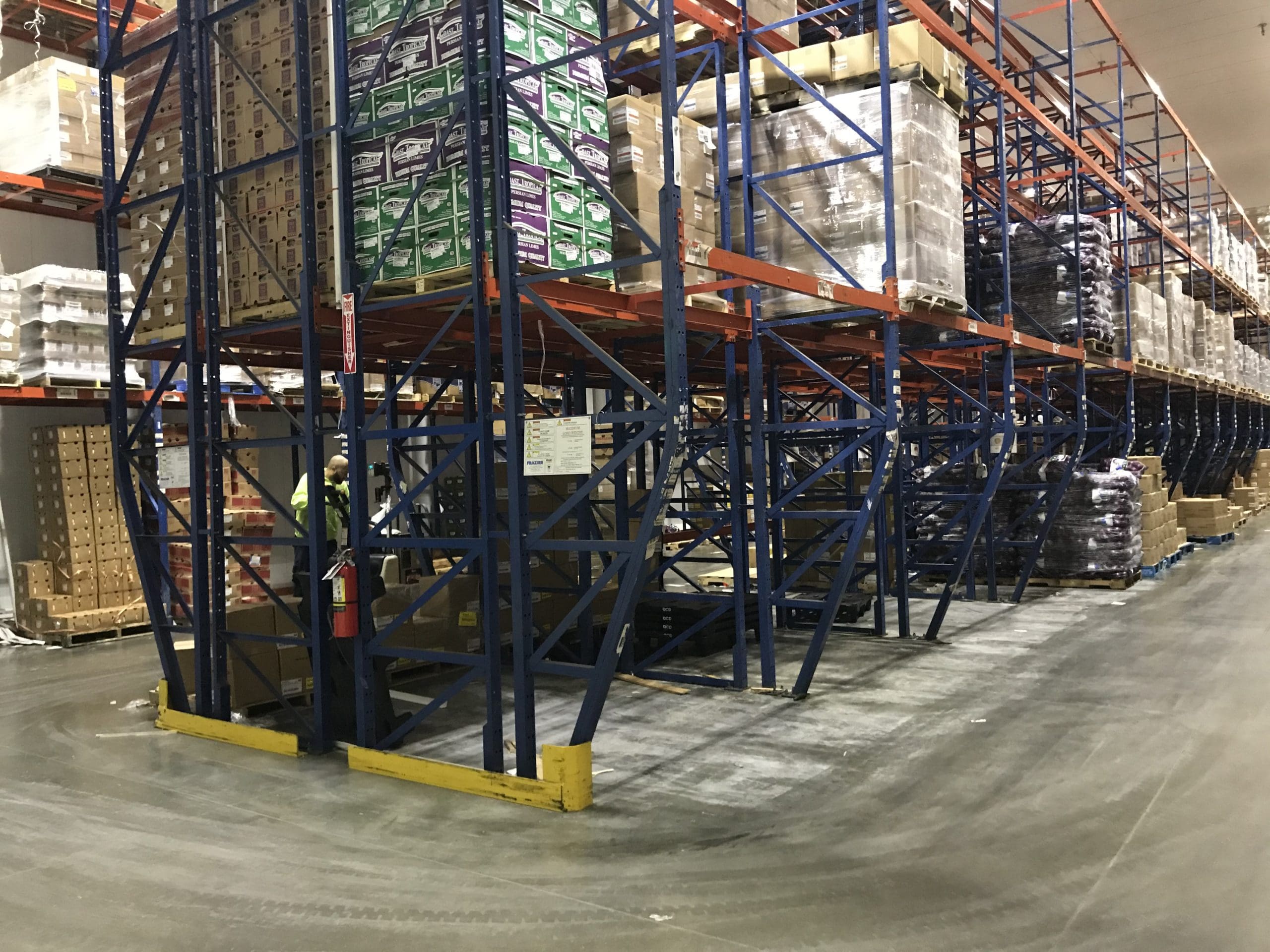 Empty and full selective pallet racks in a large warehouse